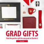 Flat lay image of diploma frame, red graduation cap with white tassel, watch, red tie with SD Paw logo, red padfolio, red mug, alumni license plate frame and graphic below that says, 'GRAD GIFTS Find the perfect gift for any grad at Charlie's! Shop Gifts.'
