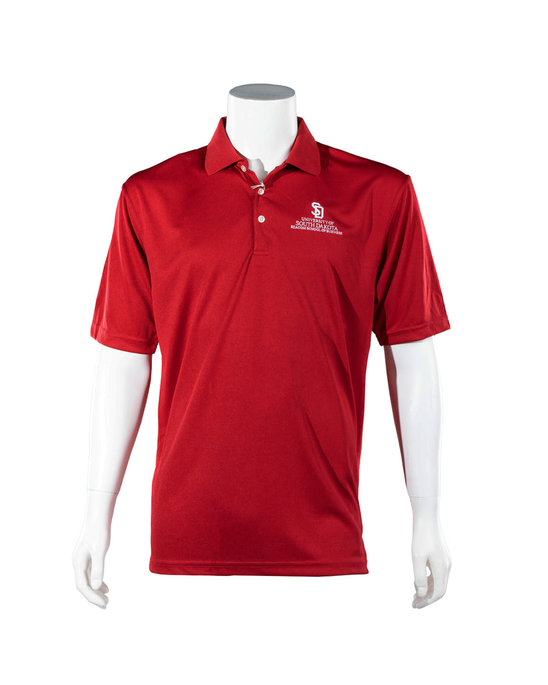 Red polo with white embroidered SD logo and text below, 'UNIVERSITY OF SOUTH DAKOTA BEACOM SCHOOL OF BUSINESS.'