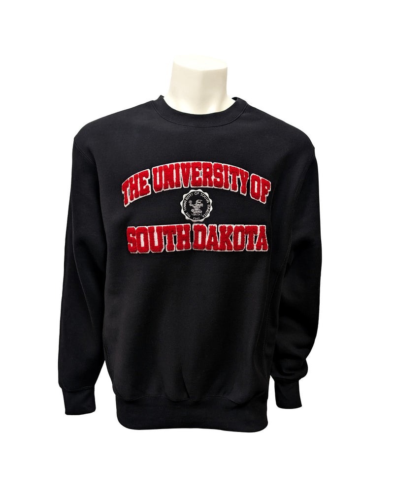 Black crew with chenille red and white letters, 'THE UNIVERSITY OF SOUTH DAKOTA,' with white embroidered university seal in the center. 