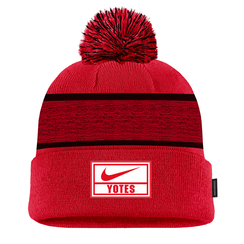 Red Nike beanie with black stripes, black and red pom and white and red Nike logo and 'YOTES' on cuff. 