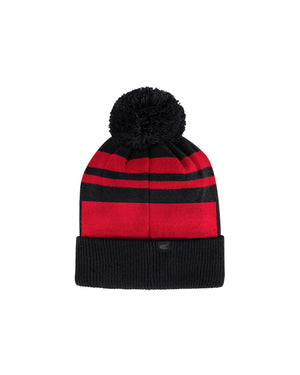 Back of red and black beanie with black pom puff on top. 
