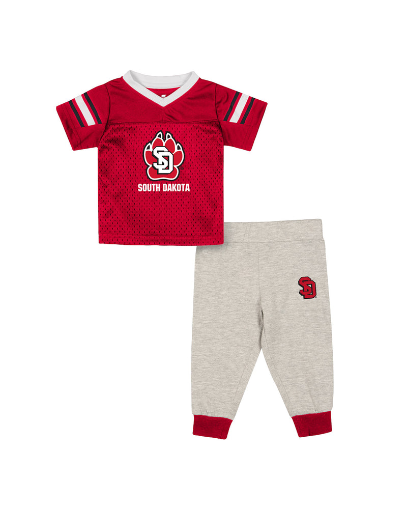 Red infant jersey with full color SD Paw logo and 'SOUTH DAKOTA' below it along with white and black stripes on sleeves. Gray sweatpants with red cuffs and SD logo on upper left thigh.