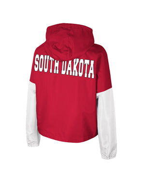 Back of women's cropped red hooded poly jacket with white sleeves and white, 'SOUTH DAKOTA,' across upper back.