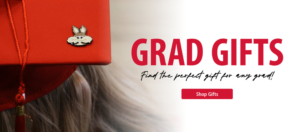 Close-up of a red grad cap with a Charlie Coyote pin on it and text to the right, 'GRAD GIFTS Find the perfect gift for any grad!' with a Shop Gifts button.