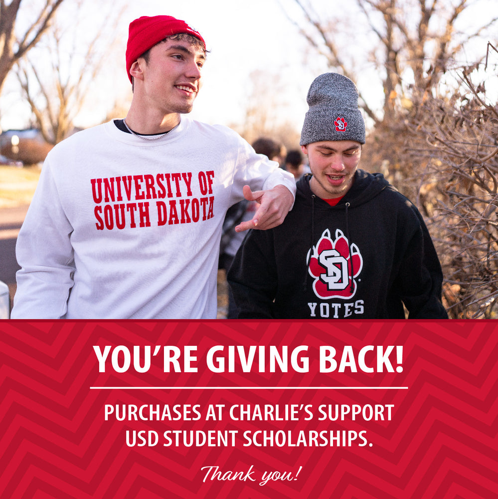Image of two guys walking on campus and a red graphic that says, 'You're Giving Back! Purchases at Charlie's support USD student scholarships. Thank you!'