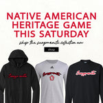 Graphic with red text 'NATIVE AMERICAN HERITAGE GAME THIS SATURDAY shop the sungmanitu collection now,' with image of two black sweathshirts, a gray tee and a gray long-sleeve with the word sungmanitu on them. 