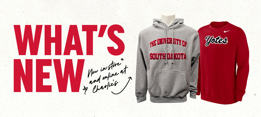 Graphic with paper textured background and red text, 'WHAT'S NEW,' with smaller black handwriting text, 'Now in-store and online at Charlie's,' with an arrow pointing to a gray hoodie with chenille decoration 'THE UNIVERSITY OF SOUTH DAKOTA,' and a red Nike crew with black and white script 'Yotes.'