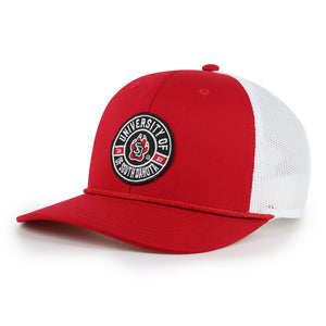 Red hat with white mesh back and black patch on front with red and white details, 'UNIVERSITY OF SOUTH DAKOTA 1862,' and SD Paw logo in the middle. Red rope detailing at base of hat.