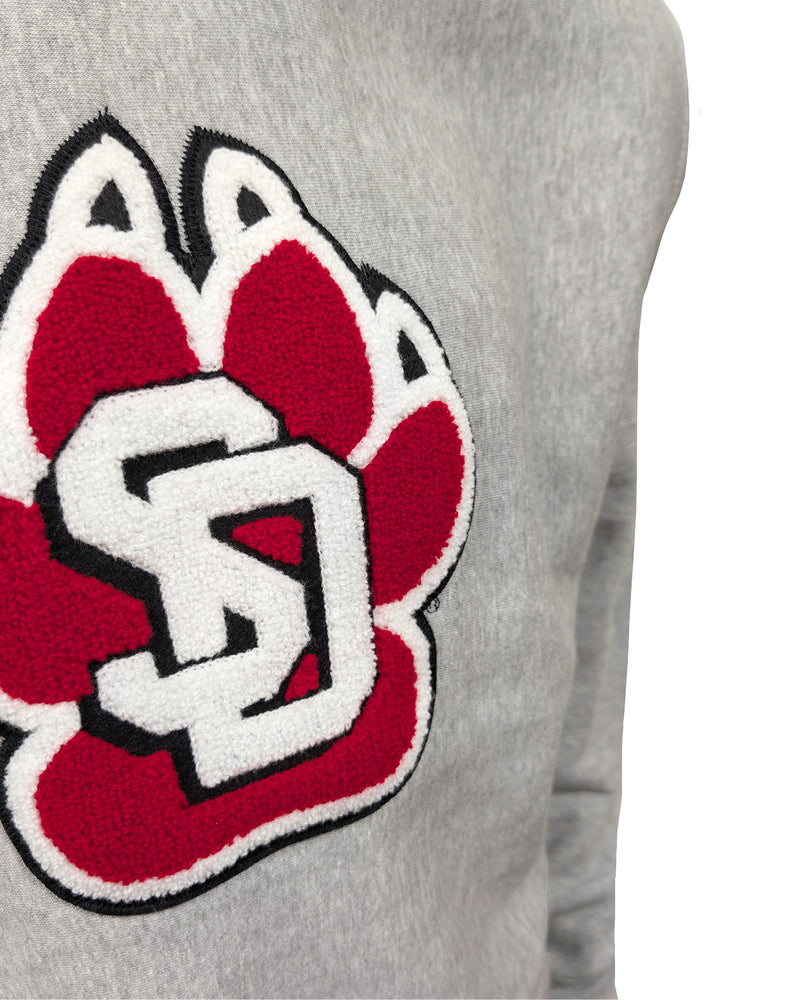 Close-up of chenille paw on gray crew.