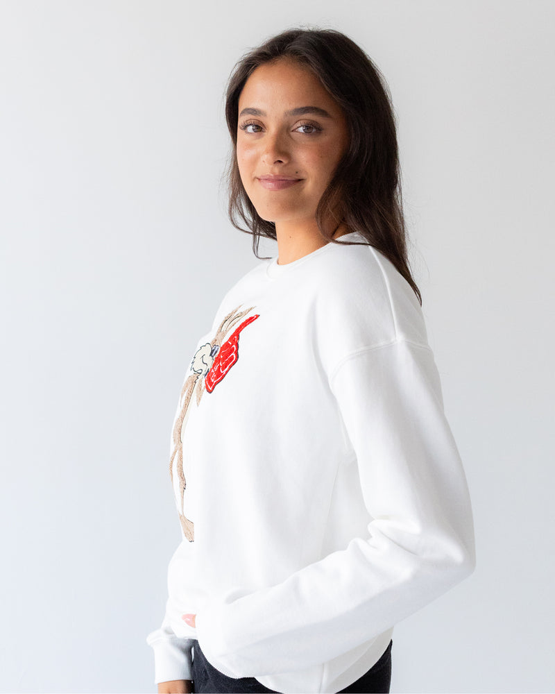 Side view of woman wearing the white crew with chenille vintage Charlie.