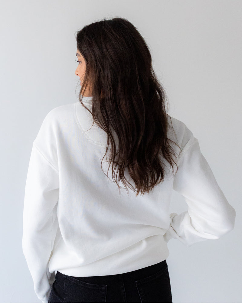 Back of person wearing a white crew.