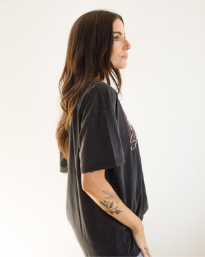 Side view of woman wearing the black oversized tee.