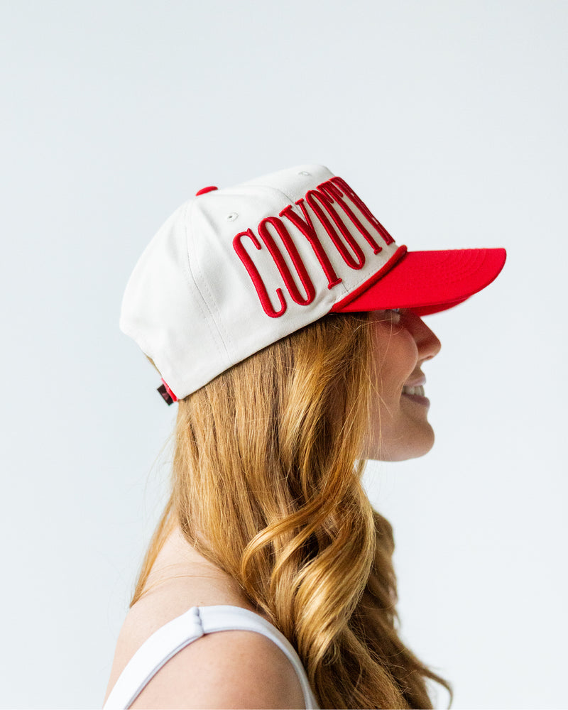 Side view showing wearing embroidered text 'COYOTES' starts.
