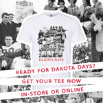 Collage of vintage black and white photos with text graphic overlaid 'READY FOR DAKOTA DAYS? GET YOUR TEE NOW IN-STORE OR ONLINE' and an image of a white tee with the vintage photo collage and 'DAKOTA DAYS' in red below it. 