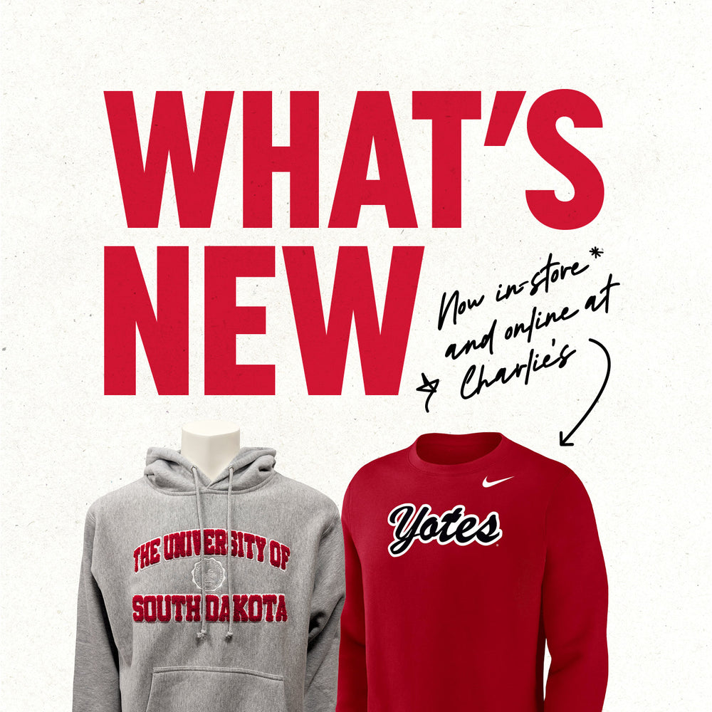 Graphic with paper textured background and red text, 'WHAT'S NEW,' with smaller black handwriting text, 'Now in-store and online at Charlie's,' with an arrow pointing to a gray hoodie with chenille decoration 'THE UNIVERSITY OF SOUTH DAKOTA,' and a red Nike crew with black and white script 'Yotes.'