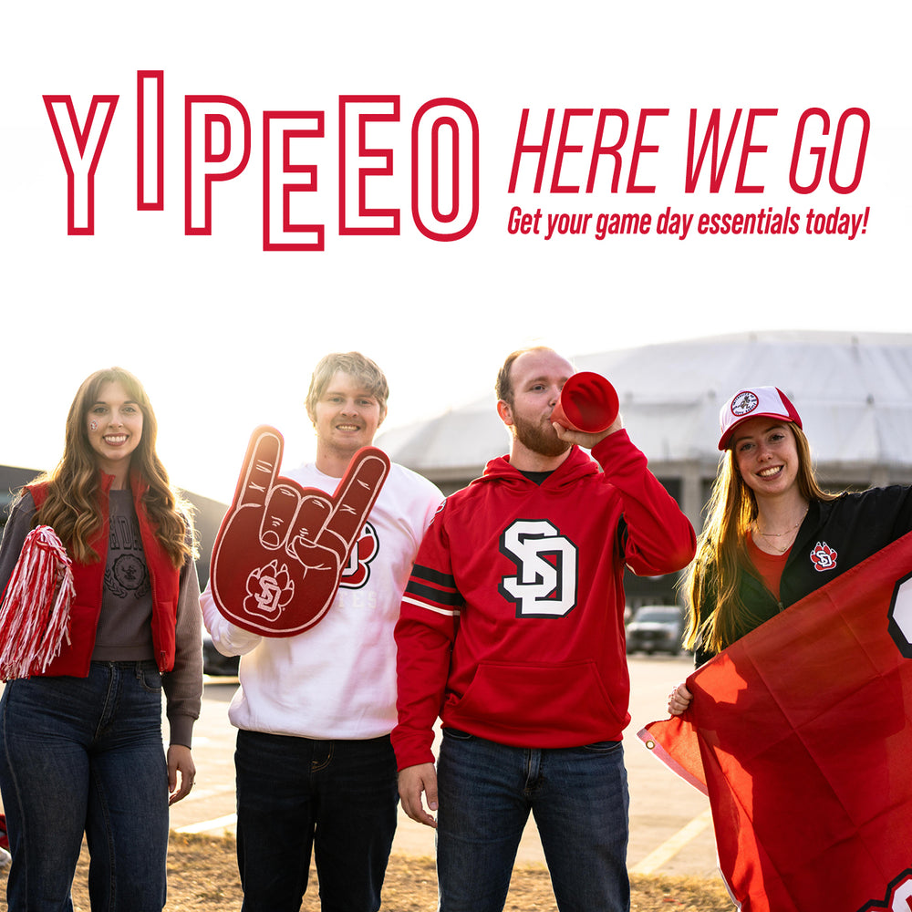 Group of fans in USD gear outside of the Dakota Dome with promotional text 'YIPEEO HERE WE GO Get your game day essentials today!'