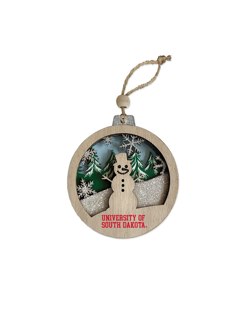 Wooden ornament with a winter scene including a snowman and 'University of South Dakota' text near bottom.