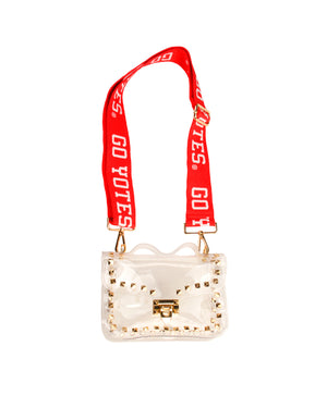 
                
                    Load image into Gallery viewer, Clear purse with gold buckle and gold studded accents and red bag strap with Go Yotes on it
                
            
