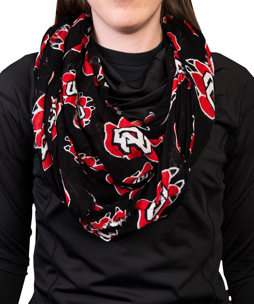 
                
                    Load image into Gallery viewer, Black scarf with red SD coyote paw prints. 
                
            